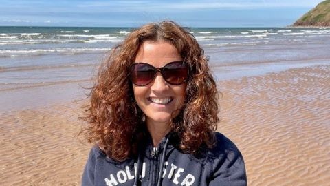 Photo of Adriènne Kelbie on a beach